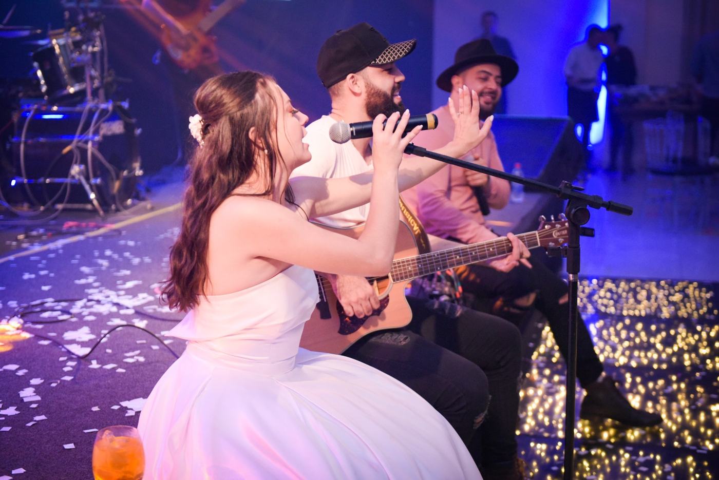 Noiva cantando ao microfone com a dupla